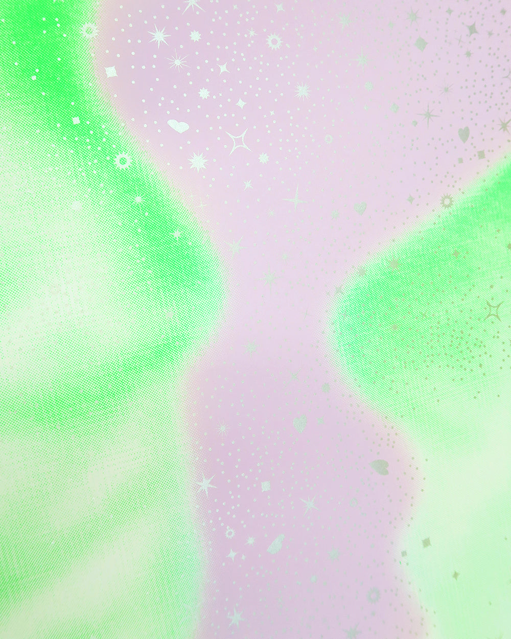 Close up of the silver stars, lavender background and fluorescent green faces.