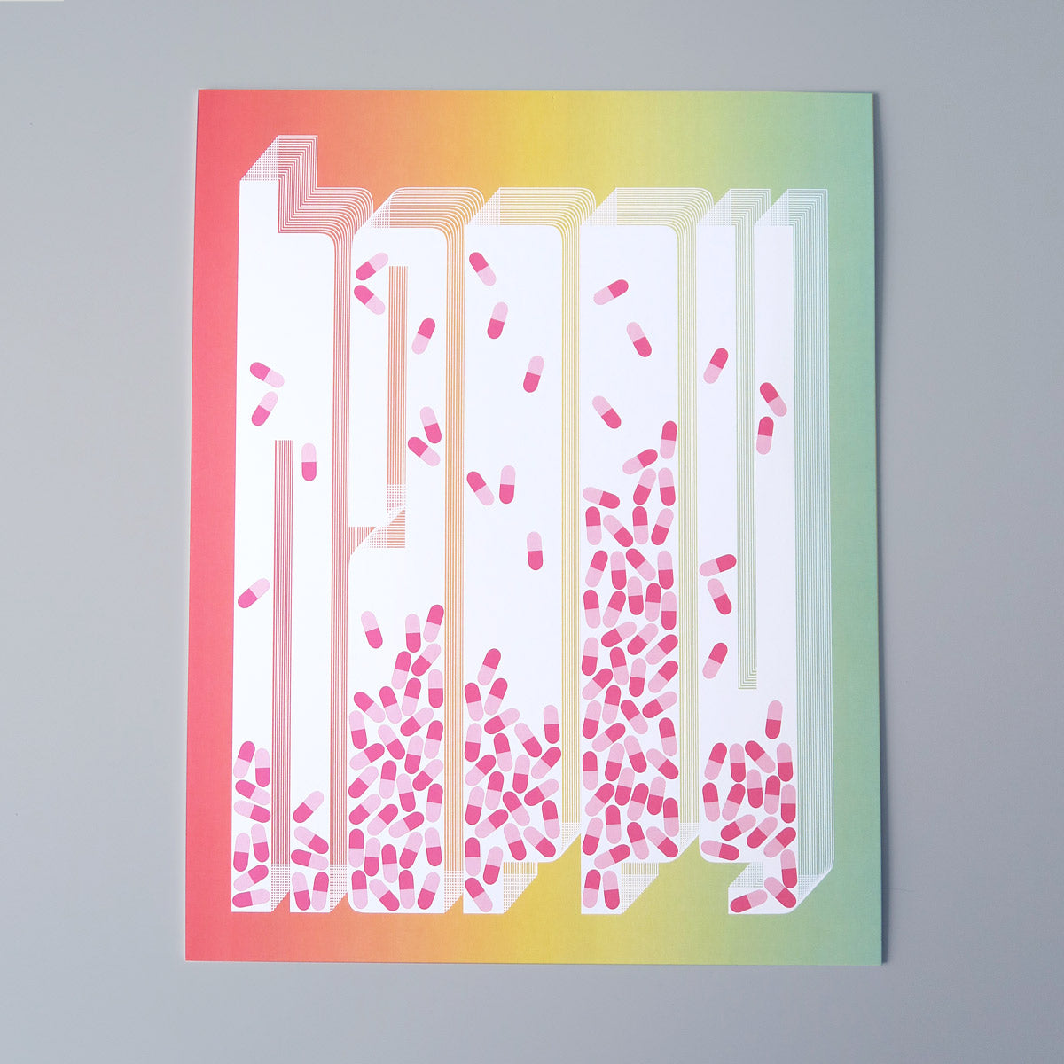 Happy Little Pill is a pop art print that is comprised of an ombre of red, yellow, and turquoise. It has pills in the centre of each letter, where the letter is knocked out white. The pills are pink and magenta.