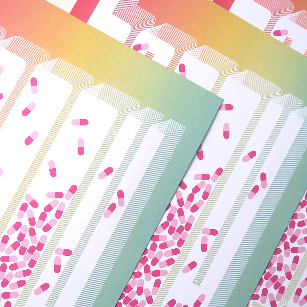 Happy Little Pill is a pop art print that is comprised of an ombre of red, yellow, and turquoise. It has pills in the centre of each letter, where the letter is knocked out white. The pills are pink and magenta.