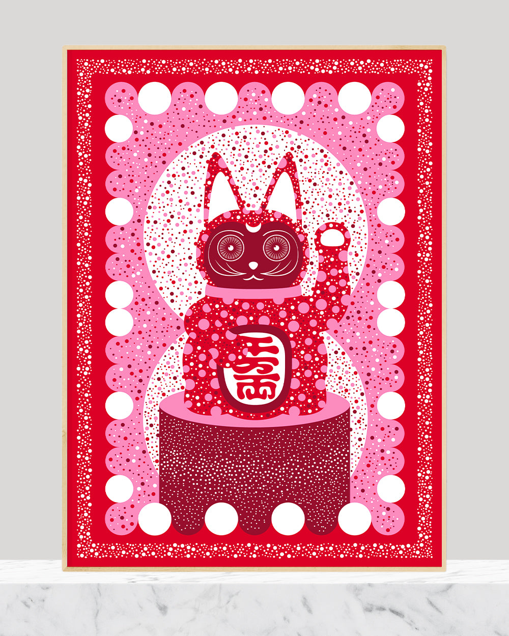 Framed lucky cat print in red, pink and white dots.