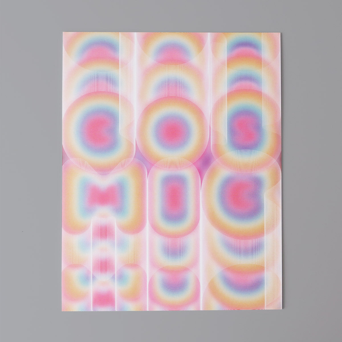 Cosmic is a pop art print comprised of a multitude of colours. Red, pinks, yellow, orange, turquoise, and magenta. It has repeating white key lines outlining each letter creating a vibration.