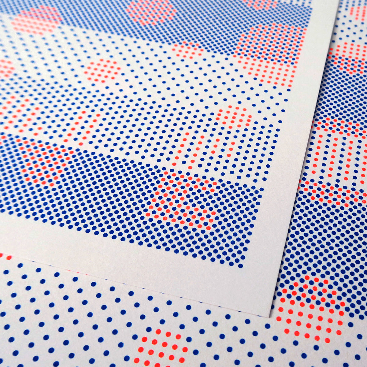 Dopamine High is a pop art print that is made up of many dots in fluorescent orange and blue. It has radial circles made of these small dots like pixels in an image. The letters that spell out DOPAMINE are also made up of small dots. It plays on Gestalt theories about how the organized whole is perceived as more than the sum of its parts.