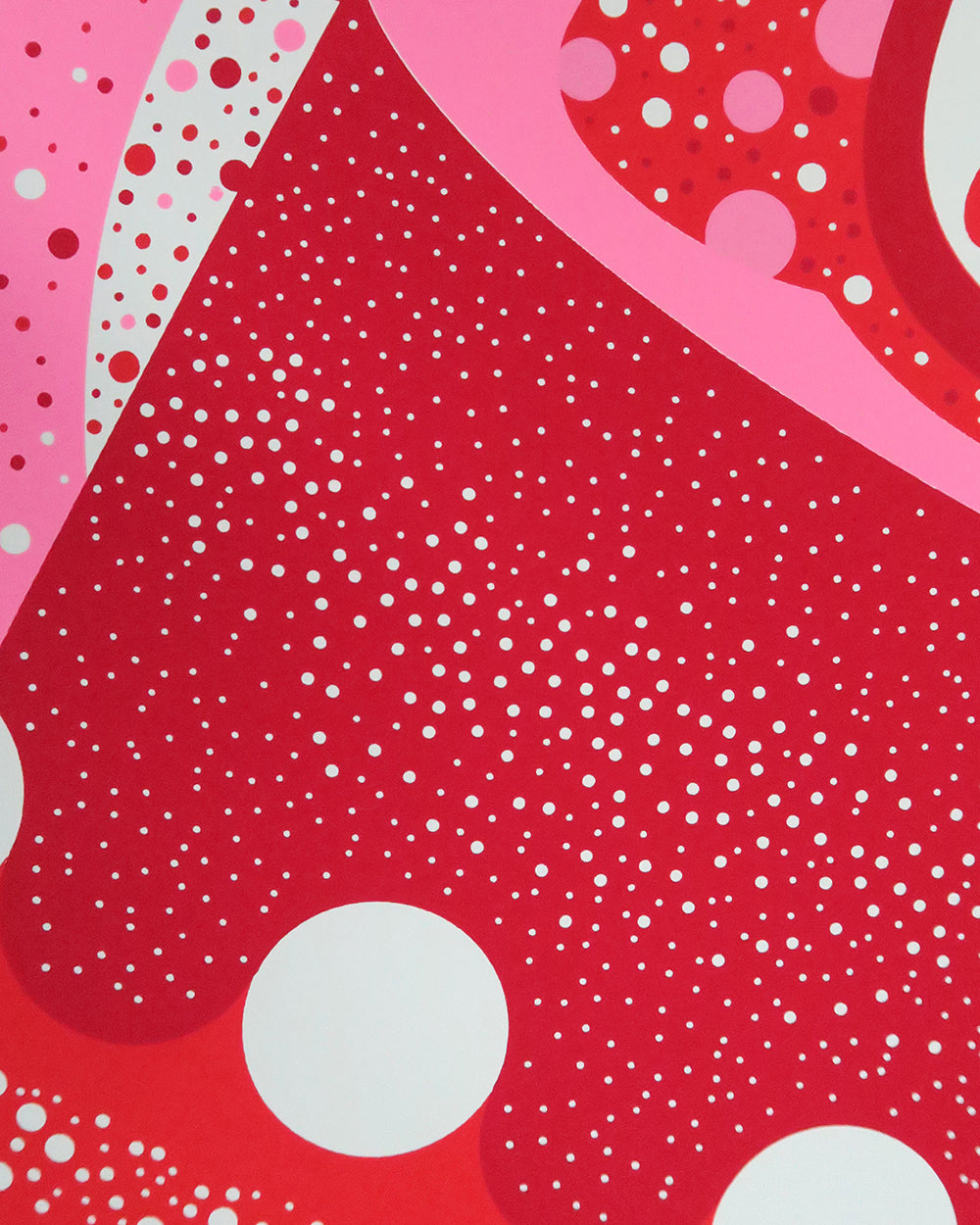 Close up of lucky cat print in red, pink and white dots.