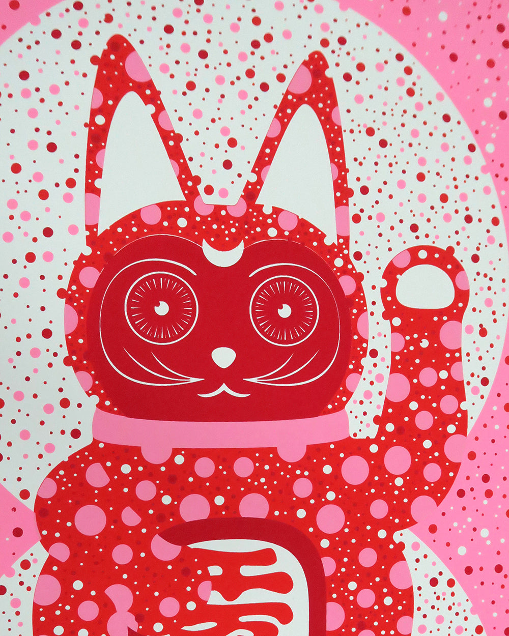 Close up of lucky cat print in red, pink and white dots.