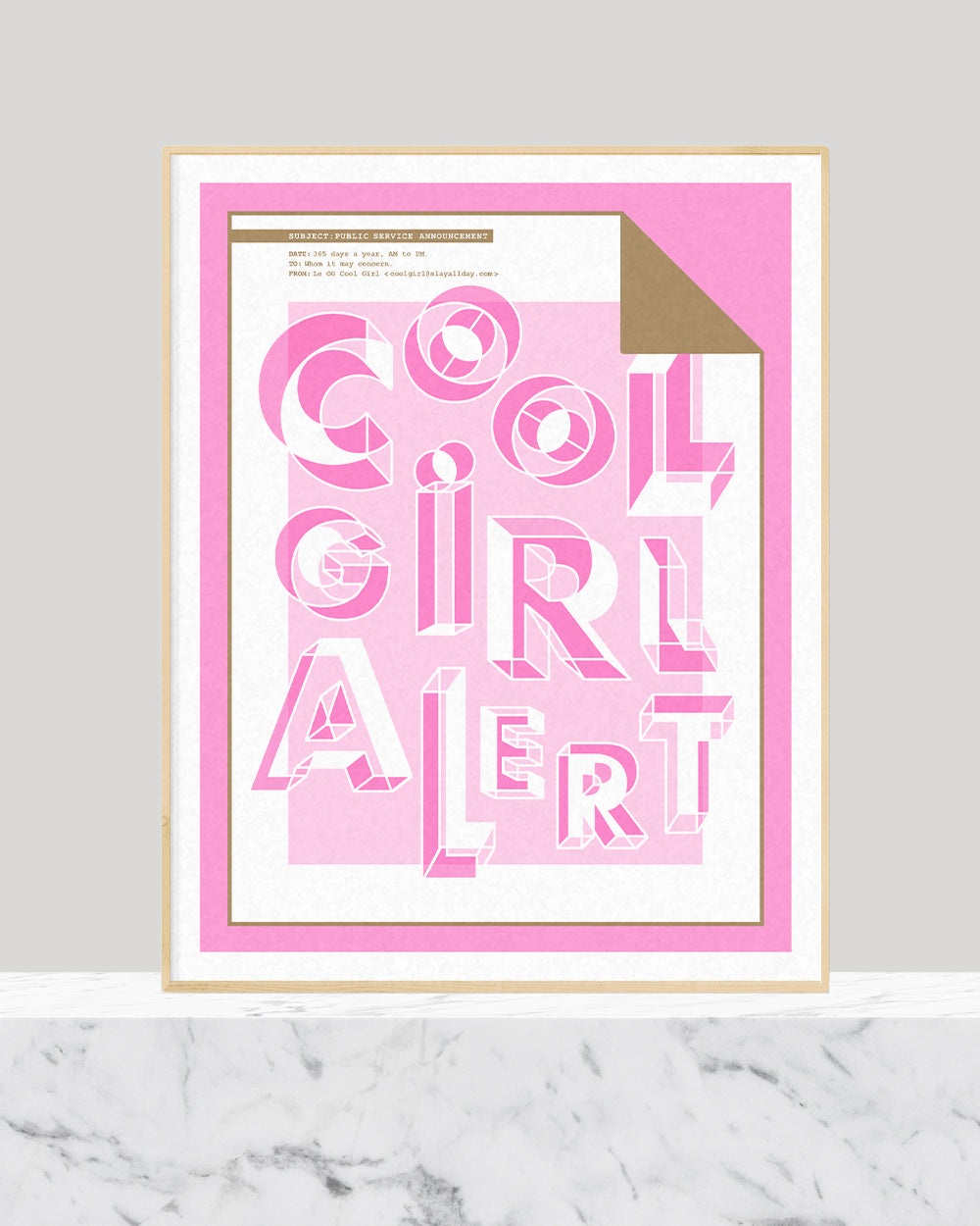 A pink and metallic gold art print with the words cool girl alert in the centre sitting on a white marble base